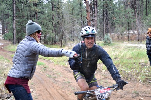 Cold, rain, mud, flat tires, and muddy snot couldn't stop the Bliss train from delivering.  Here is John getting a hand up from one of the intrepid volunteers.